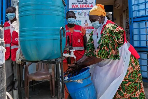 A health worker washes her hands at a temporary health clinic at the Mpondwe border crossing linking Uganda and the Democratic Republic of the Congo, June 4, 2026.