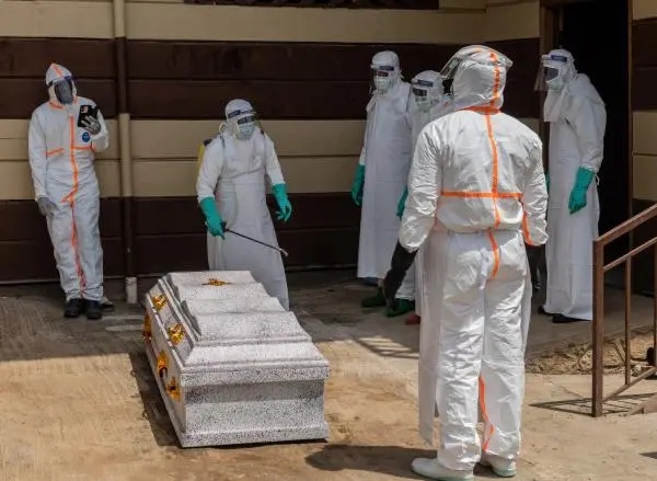 Congo health workers prepare the coffin of a university student who died of Ebola, June 12. 2026.